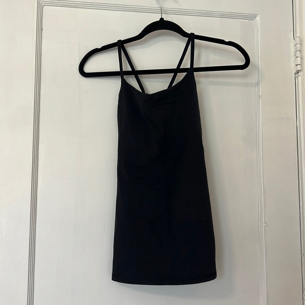 Black Lululemon tank top. Form fitting, size 4. Open back with cut out.